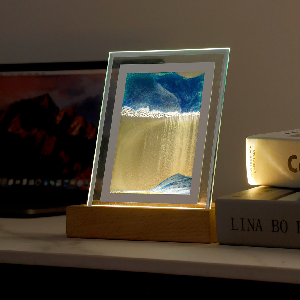 Lampe sable mouvant bleue allumée le soir, lumière LED chaude dans le socle en bois