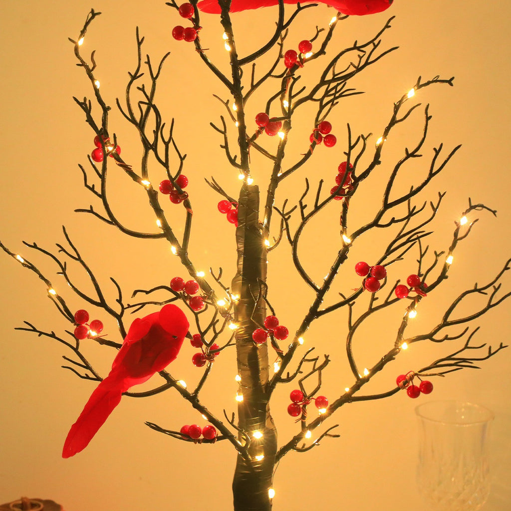 Gros plan sur un cardinal rouge perché sur une branche lumineuse