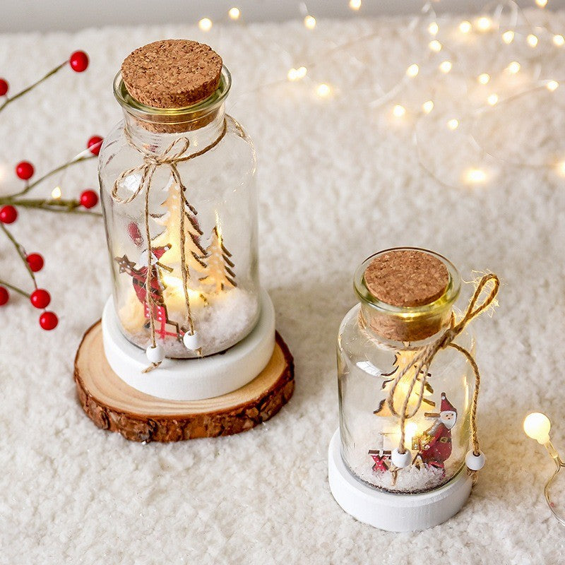 Bocal à vœux lumineux sur un rondin de bois, décor de Noël