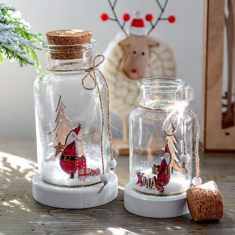Bocaux en verre éclairés avec figurines de Noël