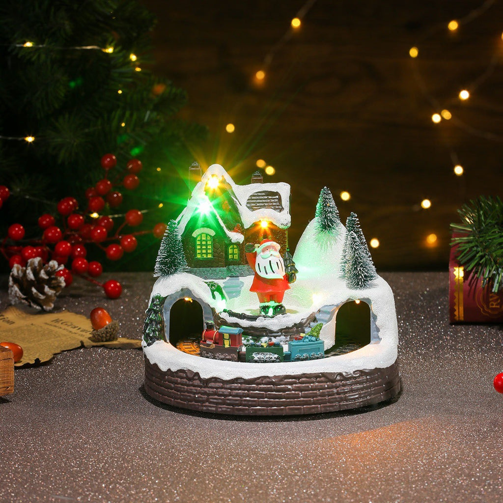 Boîte à musique village de Noël lumineuse avec Père Noël, sur une table