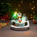 Boîte à musique village de Noël lumineuse avec Père Noël, sur une table
