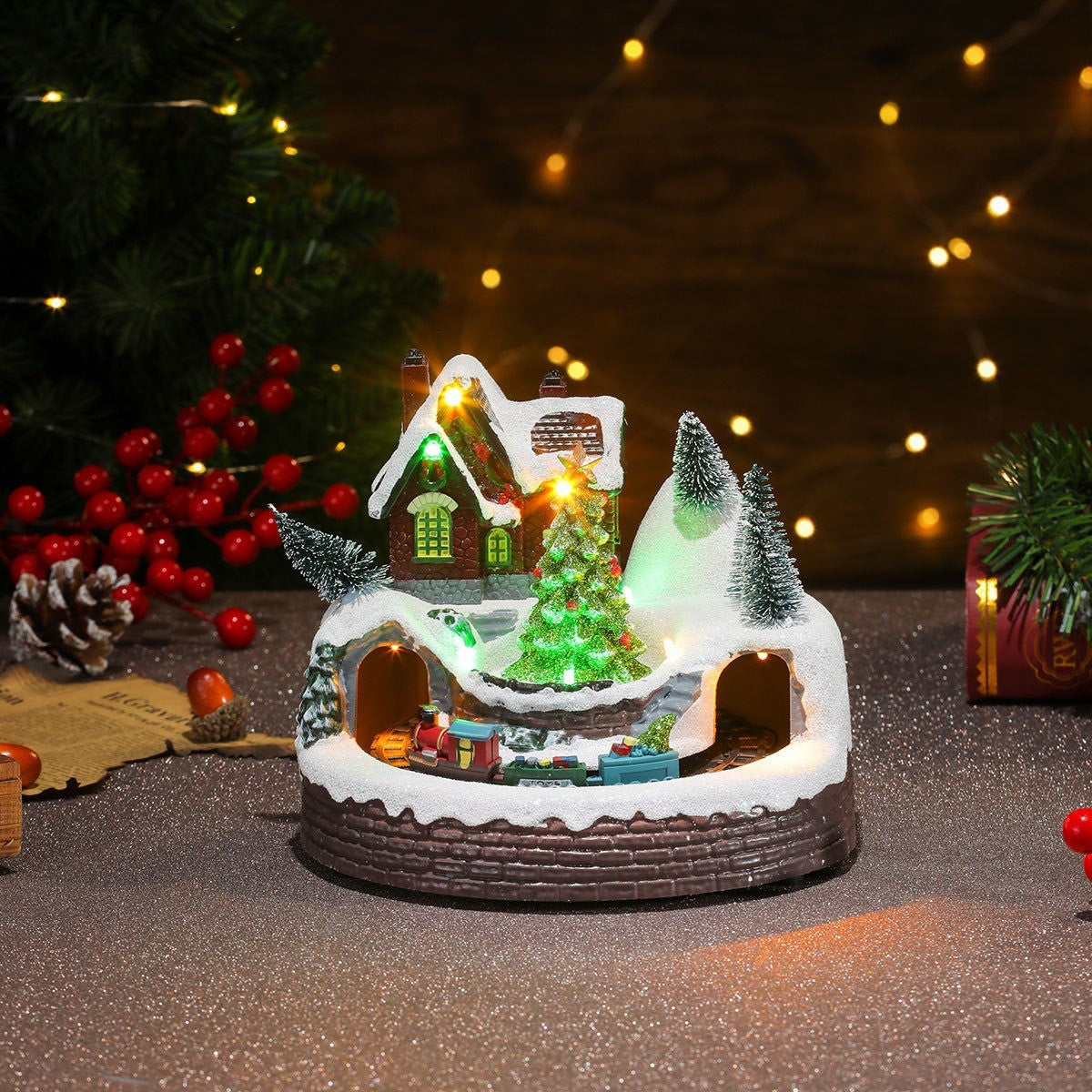 Village de Noël lumineux et tournant avec grand sapin