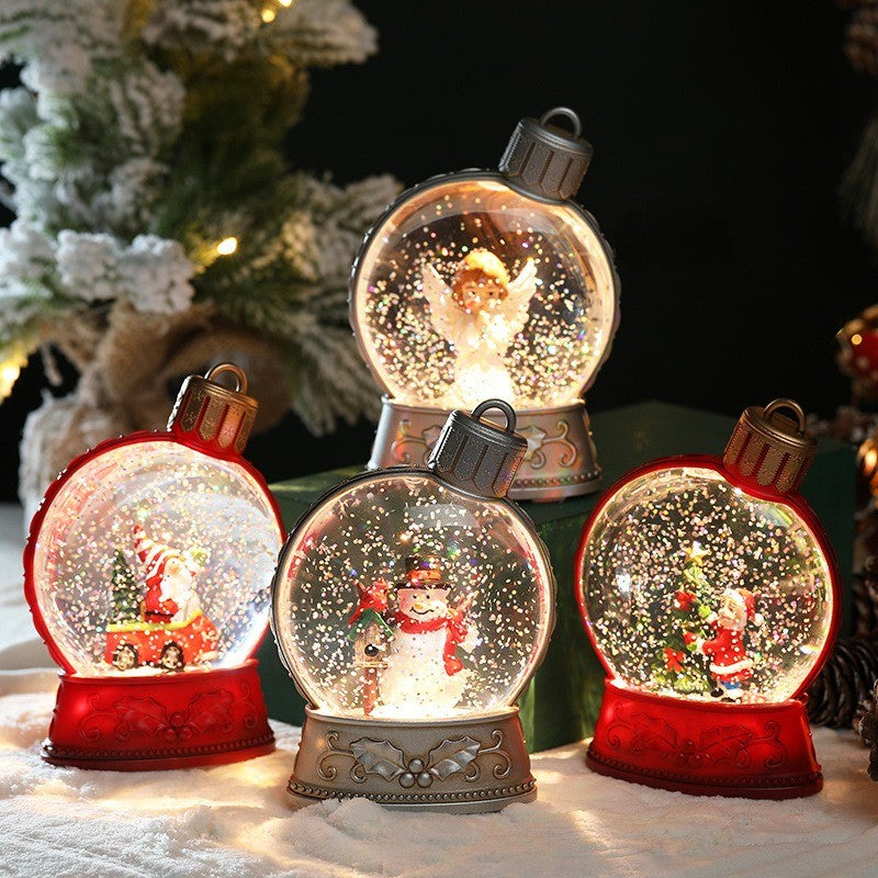 Quatre boules à neige lumineuses à paillettes : Père Noël, bonhomme de neige, sapin et ange