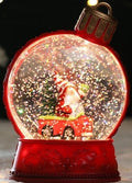 Boule à neige lumineuse Père Noël en voiture, socle rouge