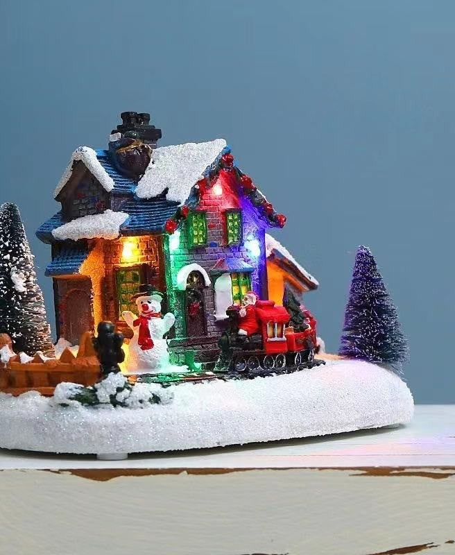 Chalet enneigé lumineux posé sur une table