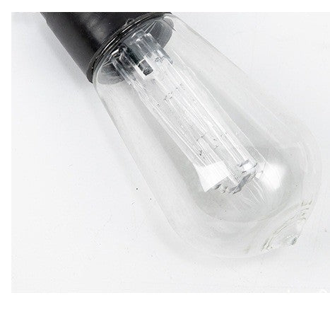 Gros plan sur une ampoule rétro transparente en forme de goutte