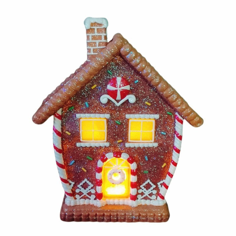Maison en pain d’épices décorée de glaçage et sucres d’orge