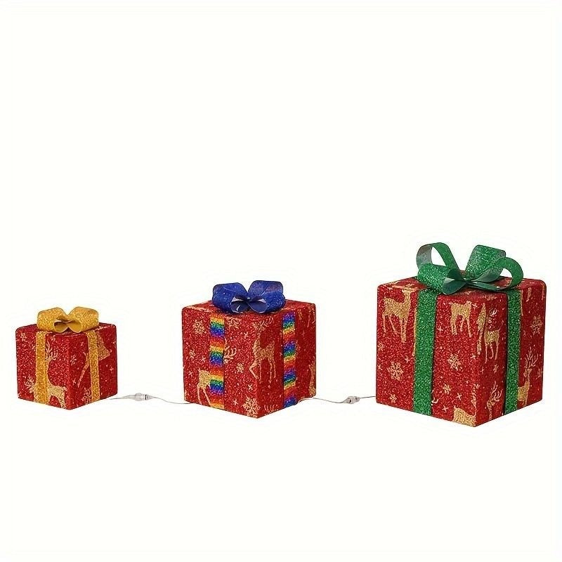 Trois paquets cadeaux lumineux à motif de rennes