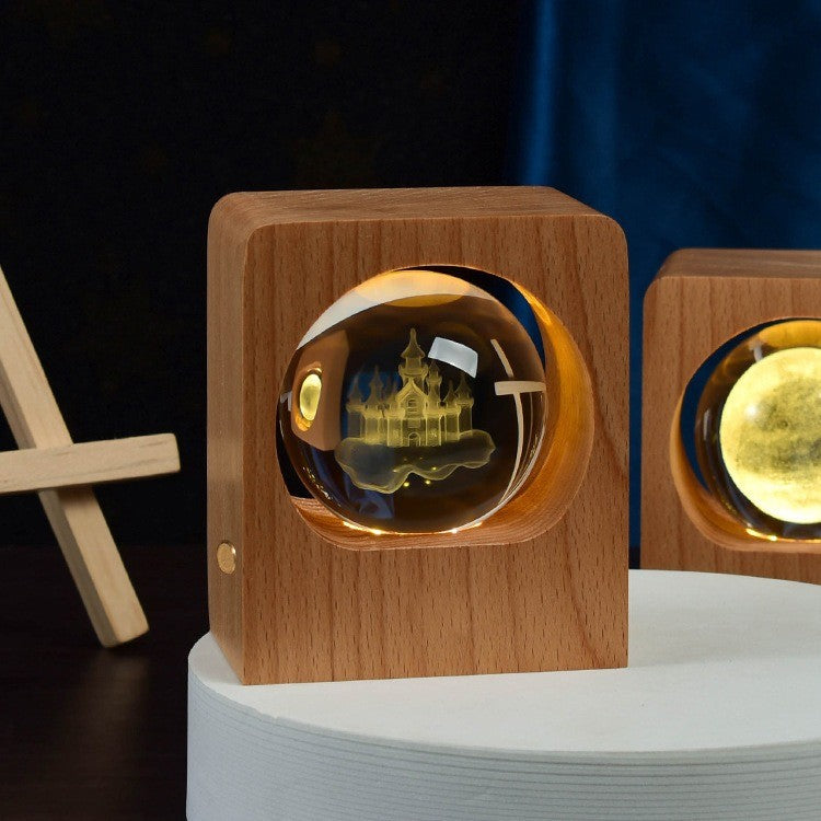 Boule de cristal gravée d’un château lumineux